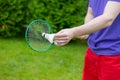 Close up young male badminton player holds racket with shuttle outdoors Royalty Free Stock Photo