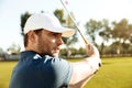 Close up of a young male golfer hitting a fairway shot Royalty Free Stock Photo