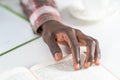 Close up on young male hand of african american man reading book making notes. Student preparing to the lecture at Royalty Free Stock Photo