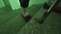 Close up of young male legs climbing upstairs with walking stick inside house entrance. Stock footage. Young drugged or