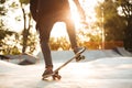 Close up of young male skateboarder training in skate park