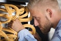 Technician Checking Server`s Wires In Data Center