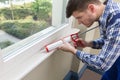 Worker Applying Silicone Sealant With Silicone Gun