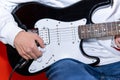 Close up of a Young man adjusting electric guitar volume. Music, instrument education, entertainment Royalty Free Stock Photo