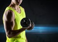 Close up of young man with dumbbell flexing biceps Royalty Free Stock Photo