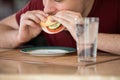 Close-up of a young man eating breakfast in the kitchen. Royalty Free Stock Photo