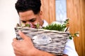 A close-up of young man gardener standing in front of door at home. Copy space. Royalty Free Stock Photo