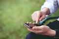 Close up of a young man hand holding using mobile smart phone outdoor Royalty Free Stock Photo