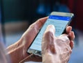 Close up of a young man hand searching map on mobile smart phone. Royalty Free Stock Photo