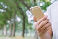 Close up young man hand using on cell phone during rest in park. Royalty Free Stock Photo