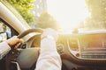 Car interior with male driver sitting behind the wheel, soft sunset light. Luxurious vehicle dashboard and electronics. Royalty Free Stock Photo