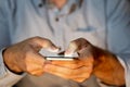 Close up of young man hands using smartphone in Phone Addiction and Mobile Gaming concept Royalty Free Stock Photo