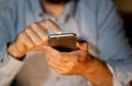 Close up of young man hands using smartphone in Phone Addiction and Mobile Gaming concept Royalty Free Stock Photo