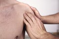 Close-up of a young man having chiropractic shoulder adjustment. Physiotherapy, sports injury rehabilitation. Osteopathy, Royalty Free Stock Photo