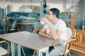 Teenager In A Cafe Drinking Cup Of Coffee, Deep In Thought. Royalty Free Stock Photo