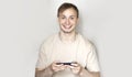 Close up of a young man leaning against a grey wall using mobile phone. Portrait of a happy business man holding a smartphone. Man Royalty Free Stock Photo