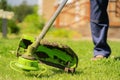 A close up of a young man with a lawnmower caring for the grass in the backyard. Royalty Free Stock Photo