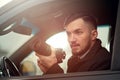 Close-up - Young Man Photorapher Sitting In The Car Royalty Free Stock Photo