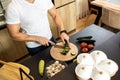 Close up of a young man preparing delicious vegan meal in his kitchen Royalty Free Stock Photo