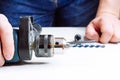 Close up of young man is preparing electric drill and changing drill bit