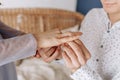 Close up young man putting wedding ring on woman bride finger, loving boyfriend proposing marriage to girlfriend Royalty Free Stock Photo