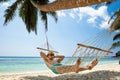 Young Man Relaxing On Hammock At Beach