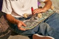 Close up of young man repairing his skateboard in the skate park. Extreme sport concept Royalty Free Stock Photo