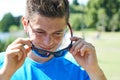 Close Up Of Young Man Running In Park Putting On Sunglasses Royalty Free Stock Photo