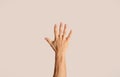 Close up of young man showing his hand, gesturing high five on light background Royalty Free Stock Photo