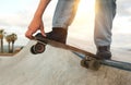 Closeup of man& x27;s hand touching skateboard during tricks outdoors Royalty Free Stock Photo