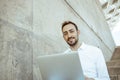 Close-up of young man smiling with computer looking at the camera Royalty Free Stock Photo