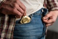 Close up of young man taking condom out of pocket in jeans. Remember about protection. Safe sex, AIDS. Pulling out Royalty Free Stock Photo