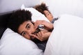 Close-up Of A Young Man Talking Privately On Cell Phone Royalty Free Stock Photo