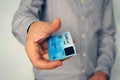 Close up of young man using fingerprint biometric card to make online payment without a PIN code. Businessman pays by