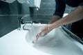 Close up. a young man washes his hands with disinfectant