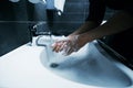 Close up. a young man washes his hands with disinfectant