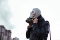 Young man wearing a gas mask on a city street Royalty Free Stock Photo