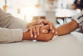 Close up of young man and woman holding hands at wooden table, from above. Loving couple expressing empathy Royalty Free Stock Photo