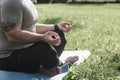 Young sporty man yogi sitting in lotus yoga pose in grass lawn park outdoors