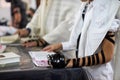 Close up, young men reading Jewish prayer and a hand with tefillin and talit.Selective focus