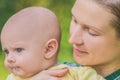 Close-up of a young mother holding a small baby in her arms Royalty Free Stock Photo