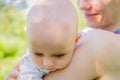 Close-up of a young mother holding a small baby in her arms Royalty Free Stock Photo