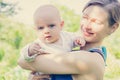 Close-up of a young mother holding a small baby in her arms Royalty Free Stock Photo