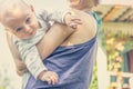 Close-up of a young mother holding a small baby in her arms Royalty Free Stock Photo