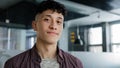 Close-up young motivated confident ambitious guy turns head looking at camera friendly and welcoming smiling happy