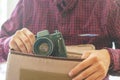 Close up young person hands holding a vintage camera f