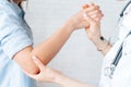 Close-up of young physiotherapist flexing the elbow Royalty Free Stock Photo