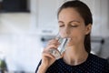 Woman holds glass drinking still water reducing thirst