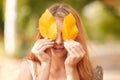 Red-haired girl closes her eyes with autumn leaves Royalty Free Stock Photo