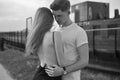 Close-up of young romantic couple is kissing and enjoying the company of each other in black and white. Young couple in love